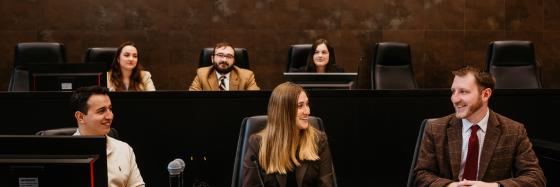 students sitting on bench in court room